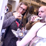 Guests tackle newspaper canapes, opening night; photo by Richard Kaby